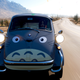 A 1957 BMW Isetta 300 sporting a livery that makes it look like Totoro in Forza Horizon 5.